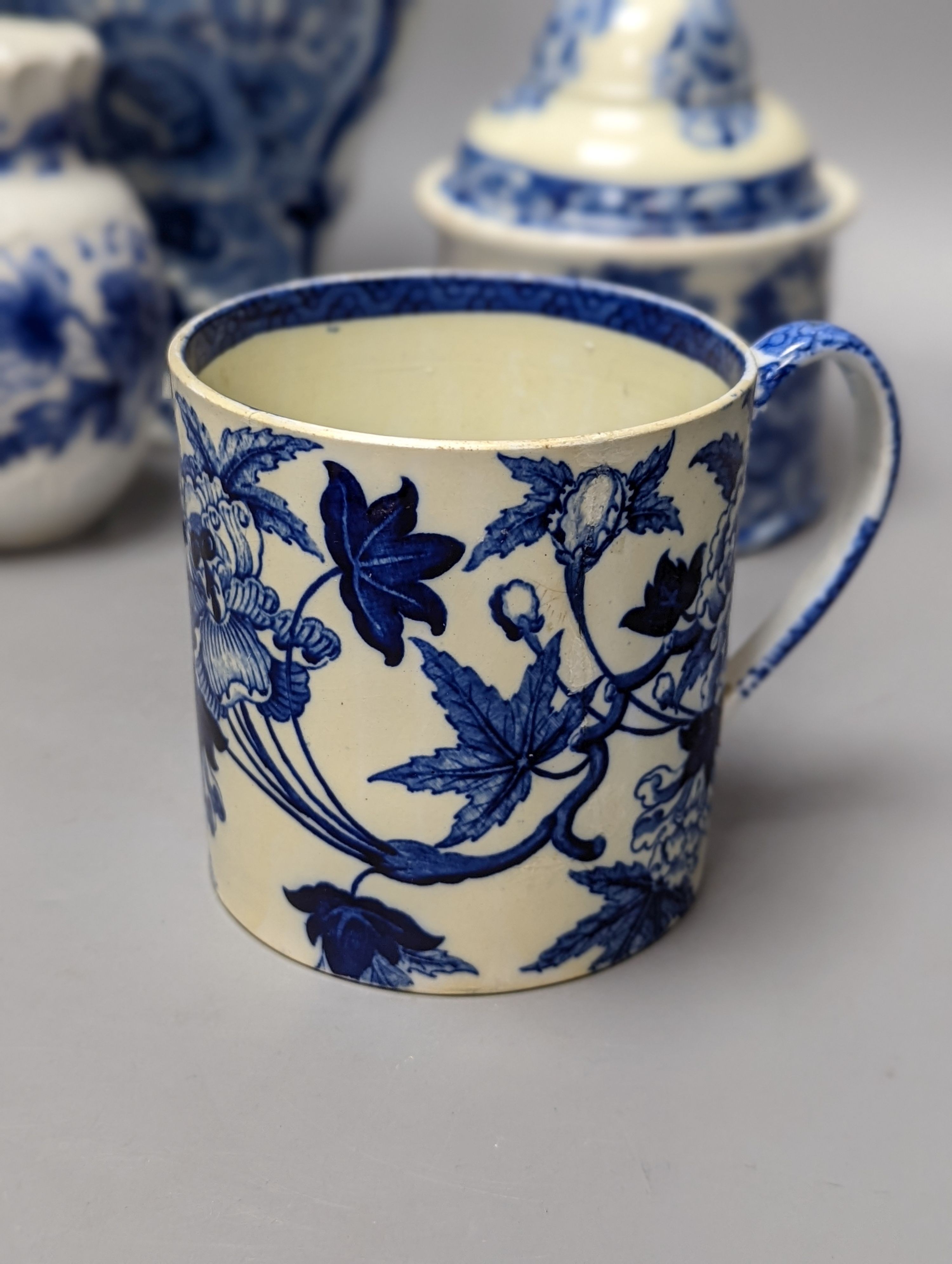 Four items of early 19th century blue and white pearlware pottery, an 18th century Delft blue and white vase and a 19th century toothbrush holder, Delft vase 22 cms high.